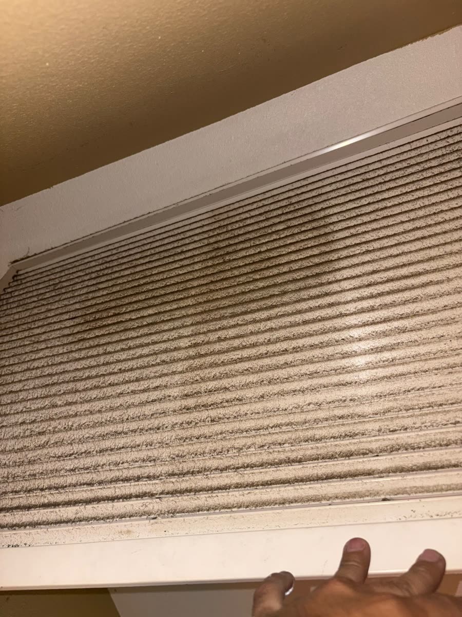 Air return grille caked with dust before cleaning