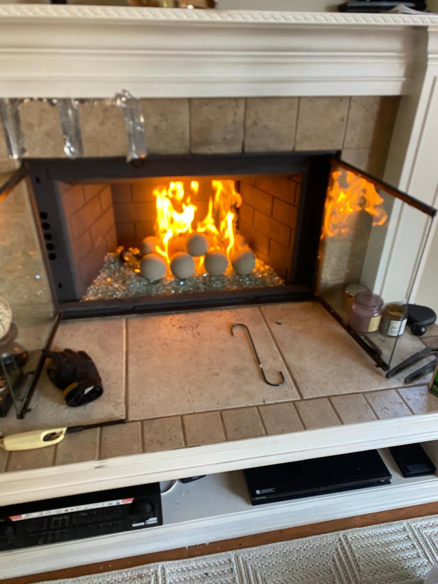 Clean fireplace with a fire burning after a GB Home Services sweep